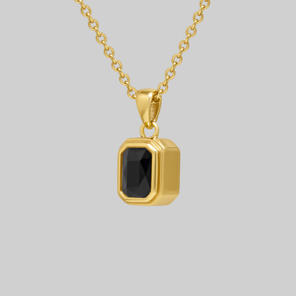 Side view of the gold Onyx cremation pendant showing the bezel setting and pendant depth