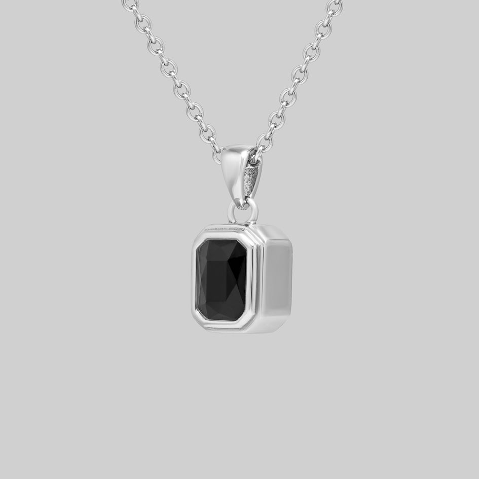 Side view of the sterling silver Onyx cremation pendant showing the bezel setting and pendant depth