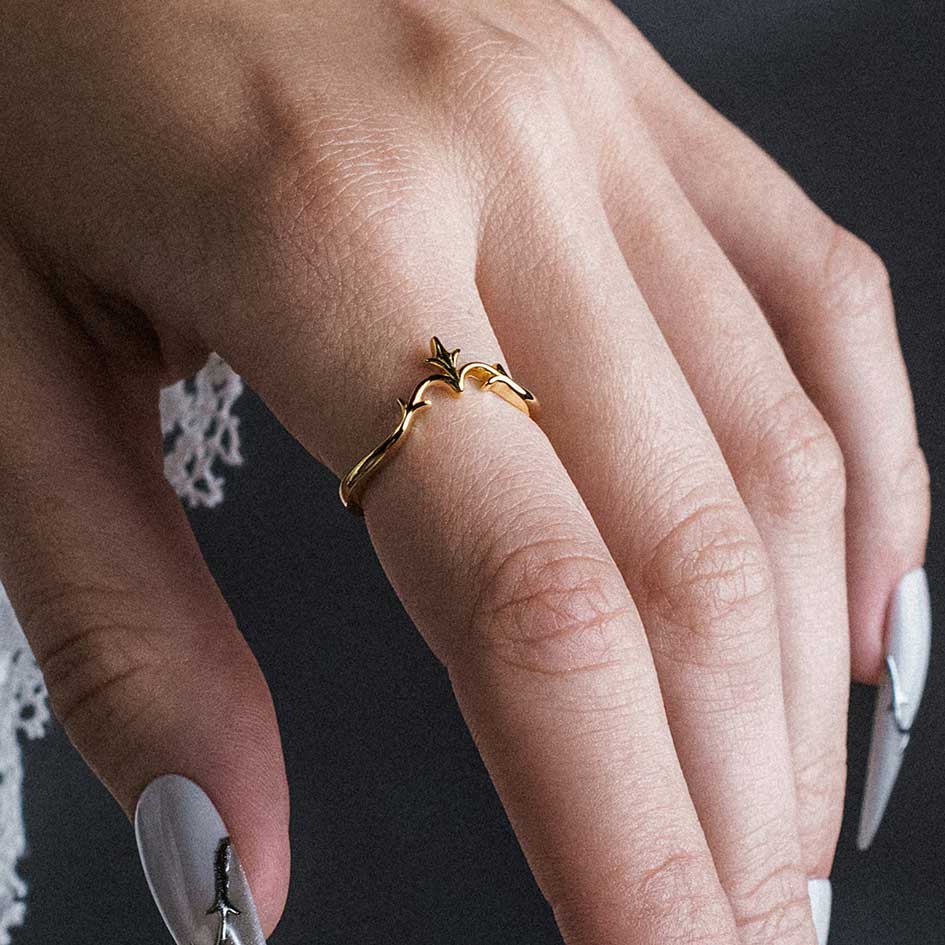 Model wearing Lisette gold heraldic lily chevron band