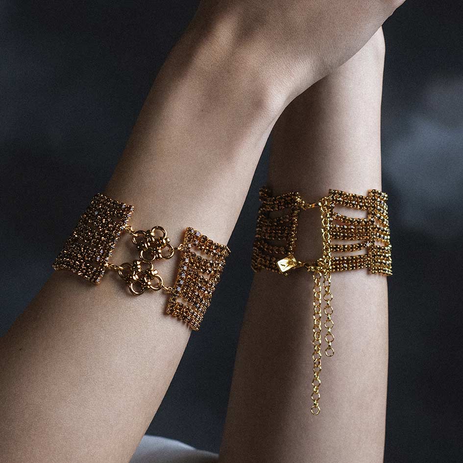 Model wearing Maryse gold chainmail dazzle chain bracelet pair