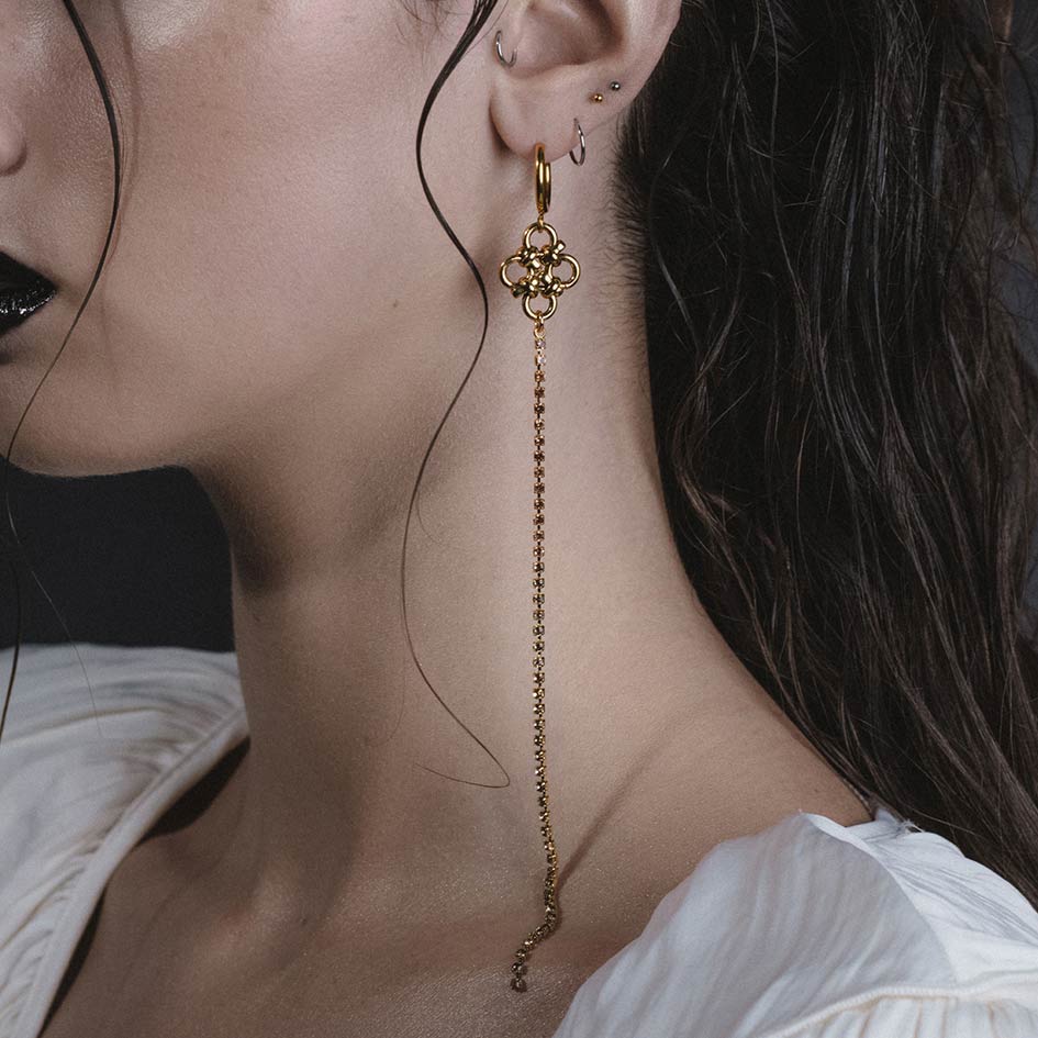 Model wearing Maryse gold chainmail dazzle chain hoop earrings