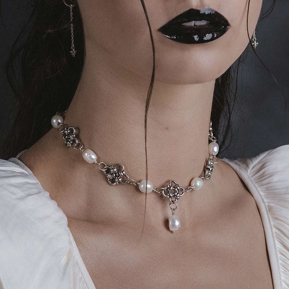 Model wearing Muriel silver chainmail and pearl collar