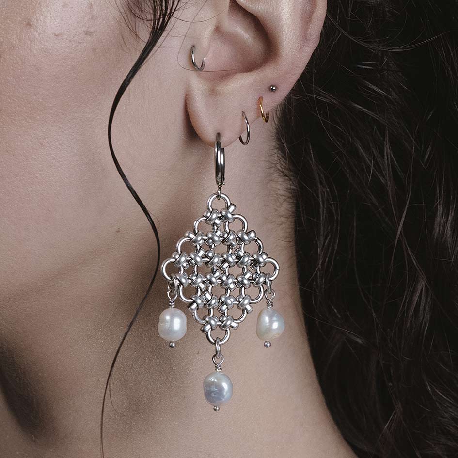 Model wearing Muriel silver chainmail and pearl hoop earrings