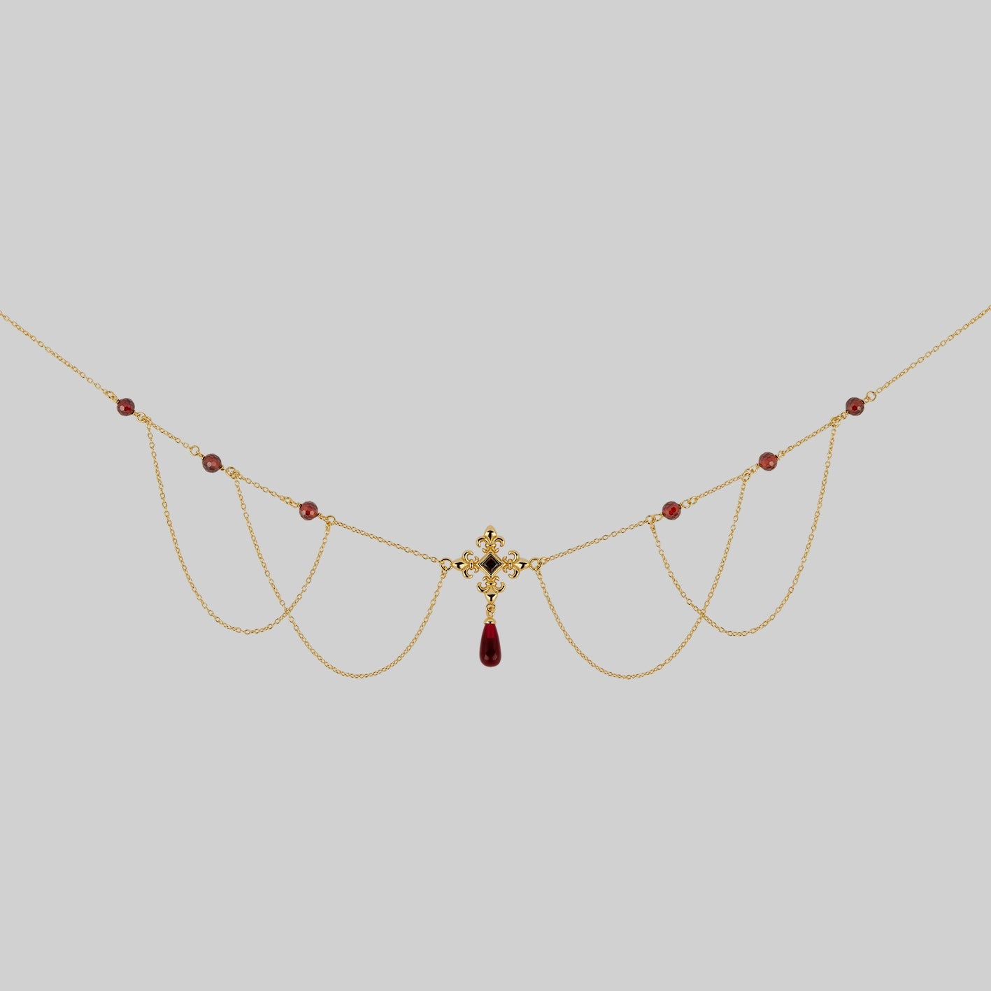 gold fleur-de-lis necklace with garnet and cz