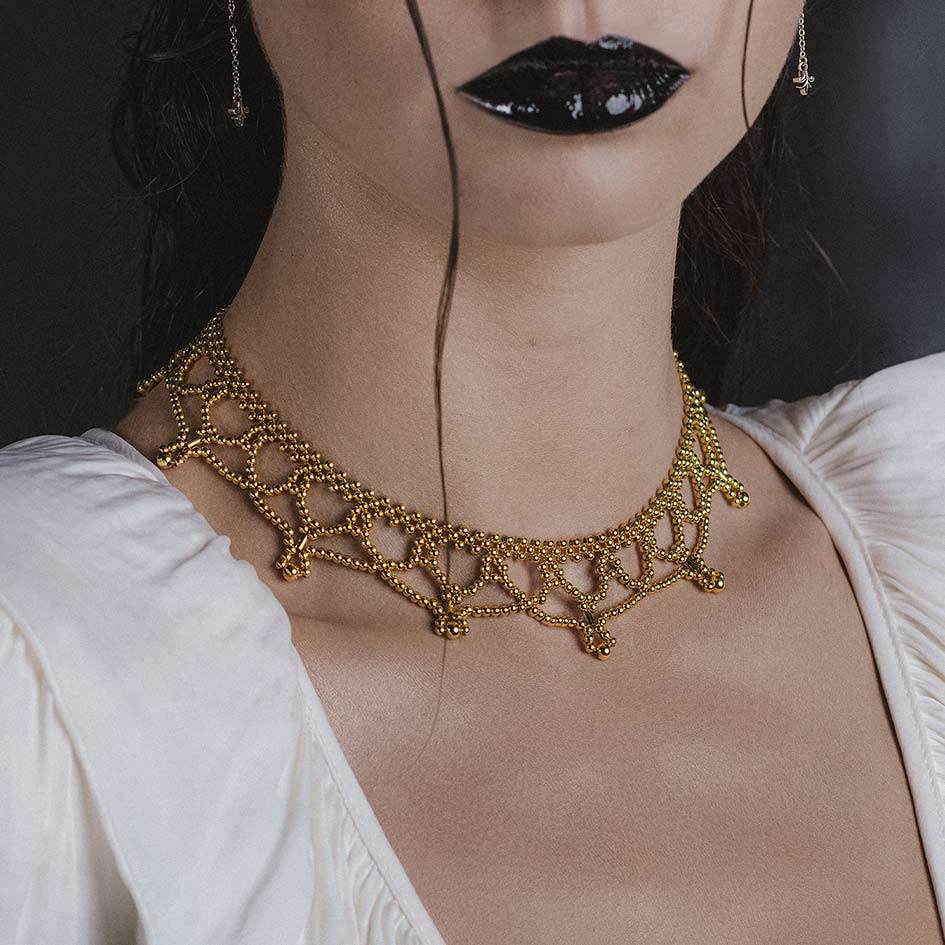 Model wearing Ninette gold tracery metal beaded collar