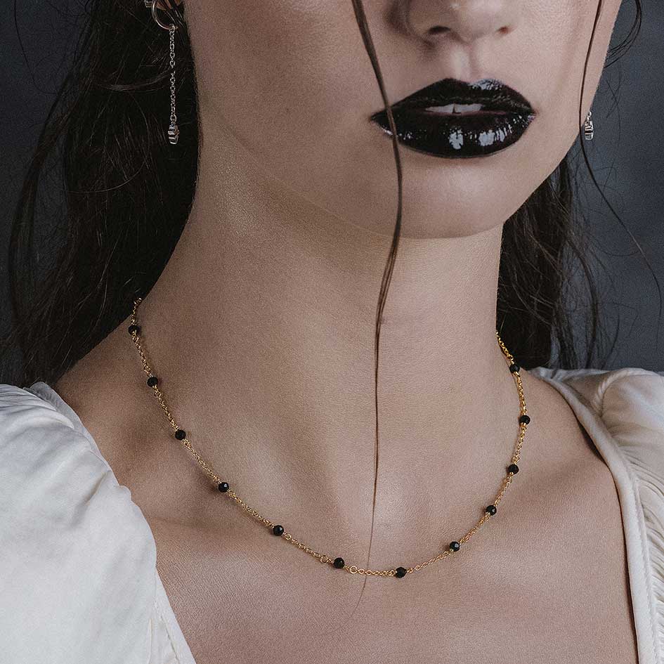 Model wearing Odette gold black spinel bead necklace