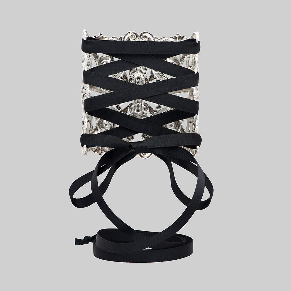 Decorative gothic corset cuff bracelet with intricate design and black lace strap ties