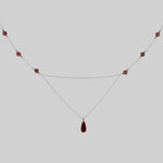 silver chain necklace with red drop and beads