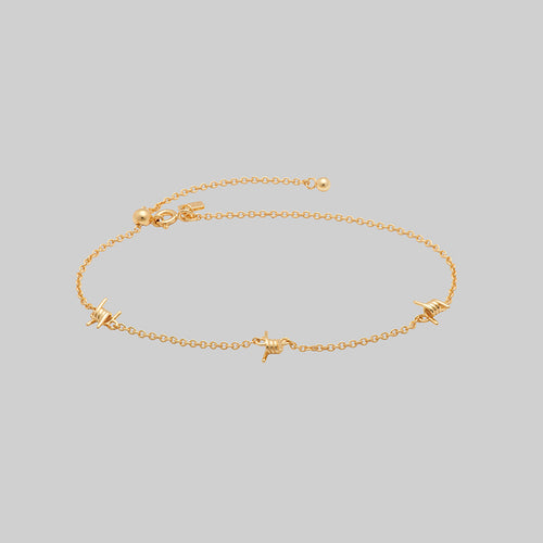 CRIMSON. Fleur de Lis Garnet Bracelet - Gold