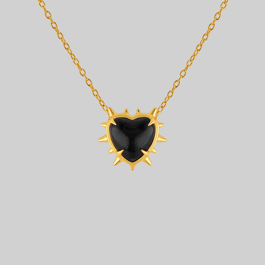 gold heart necklace with spikes