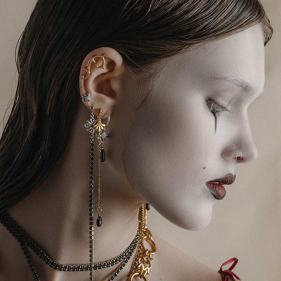 silver and gold gothic vintage earrings worn on model
