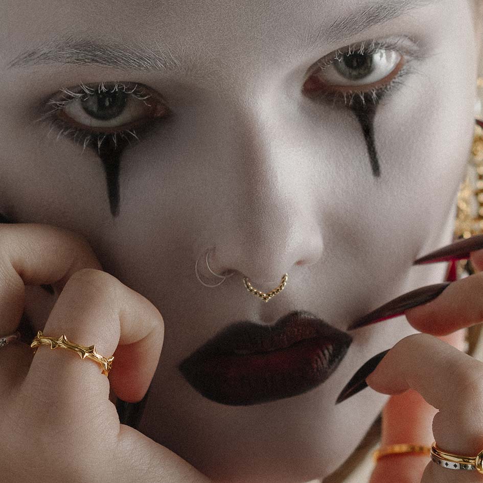 Gold ornate septum clicker ring worn on model