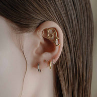 gold gothic stacked earrings worn on model