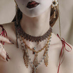 silver and gold layered detailed necklaces worn by model