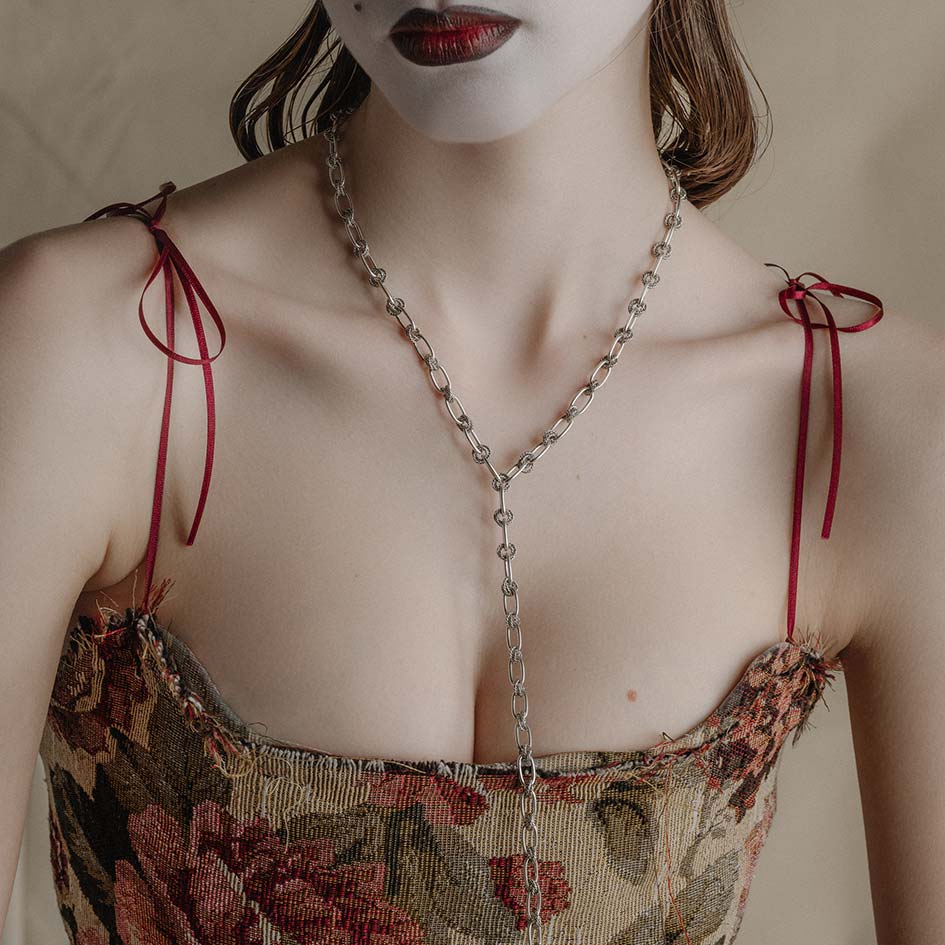 silver unique twisted knot chain worn on model