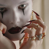 gold and silver rings stacked worn by model
