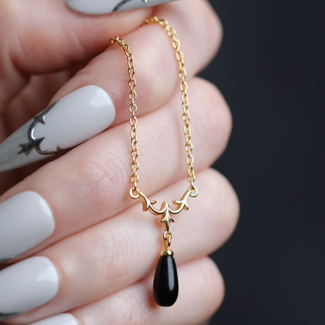 Video of Lisette heraldic lily black glass droplet necklace