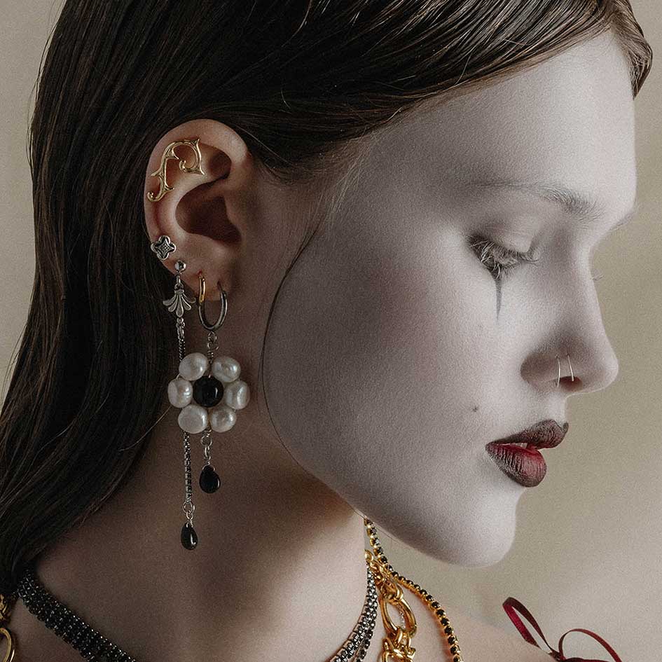 silver and gold detailed statement earrings worn by model