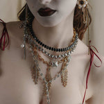silver and gold layered gothic necklaces worn by model