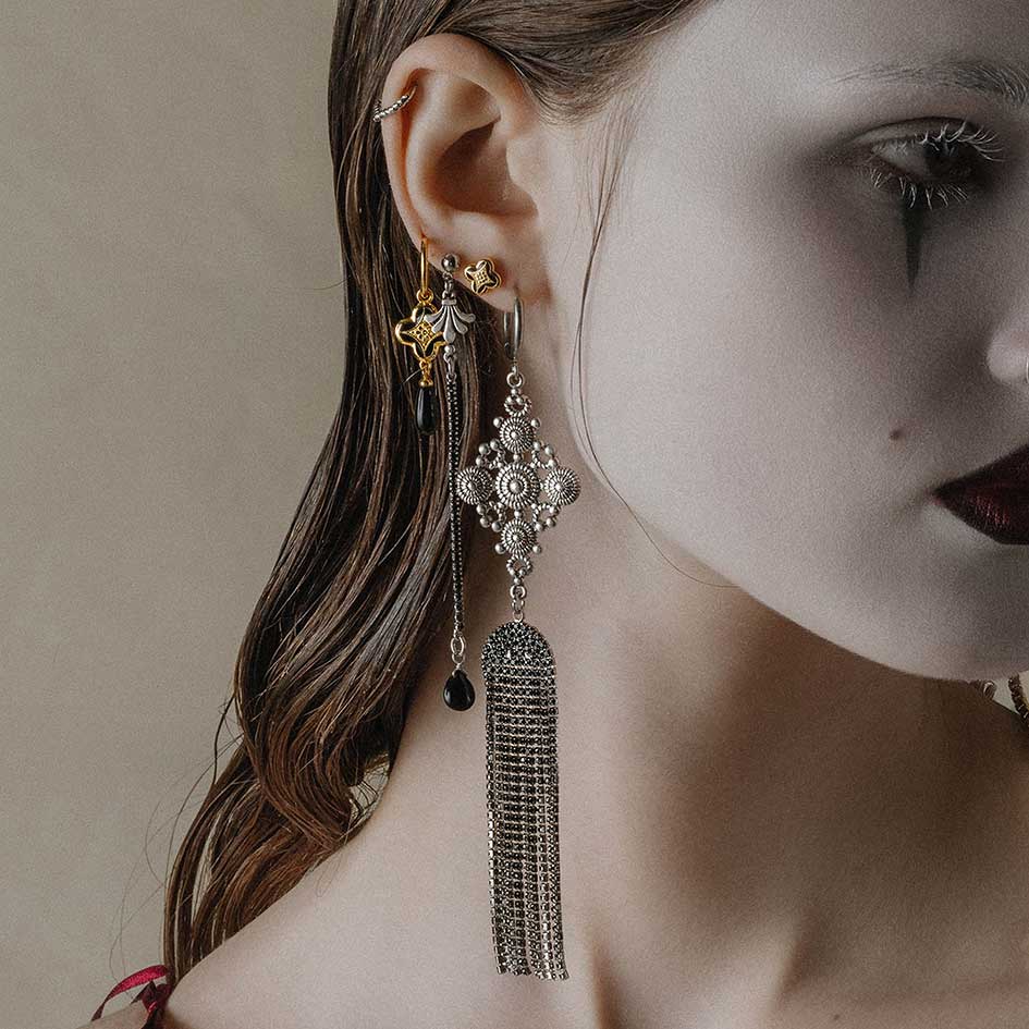 gold and silver gothic vintage earrings worn on model