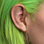 Gold and garnet daith heart earring