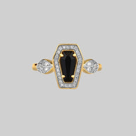 gold coffin ring with black gemstone