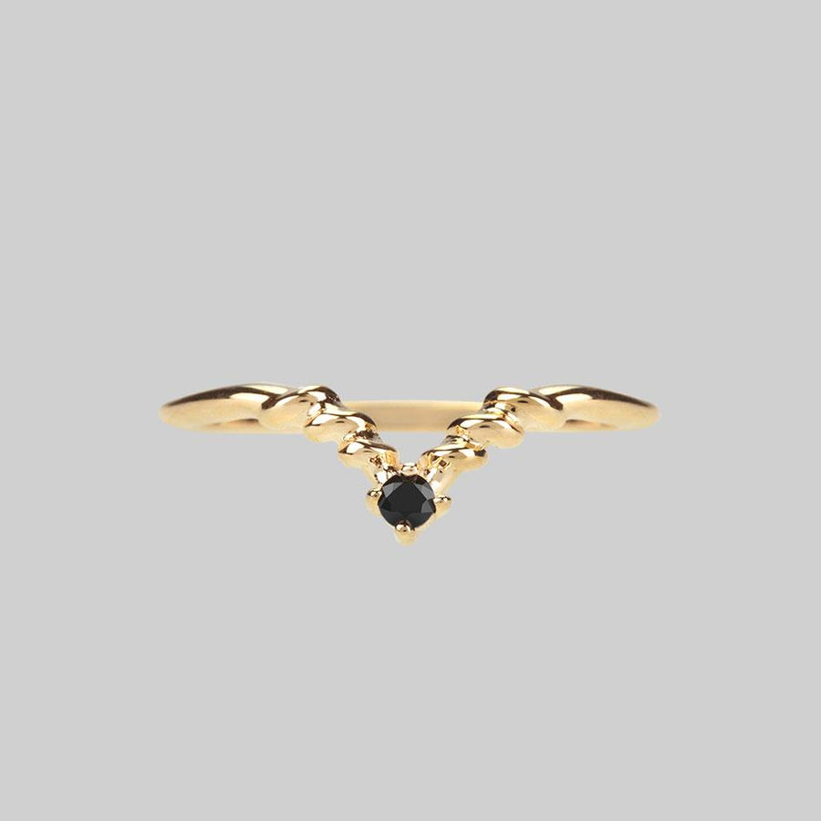 gold chevron ring with black gemstone