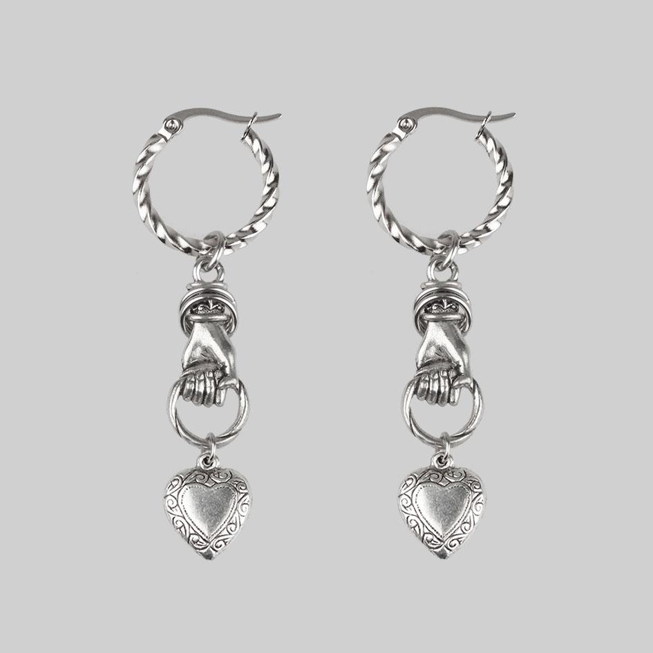 hand grasping heart silver hoop earrings 