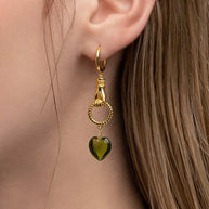 hand holding heart earrings