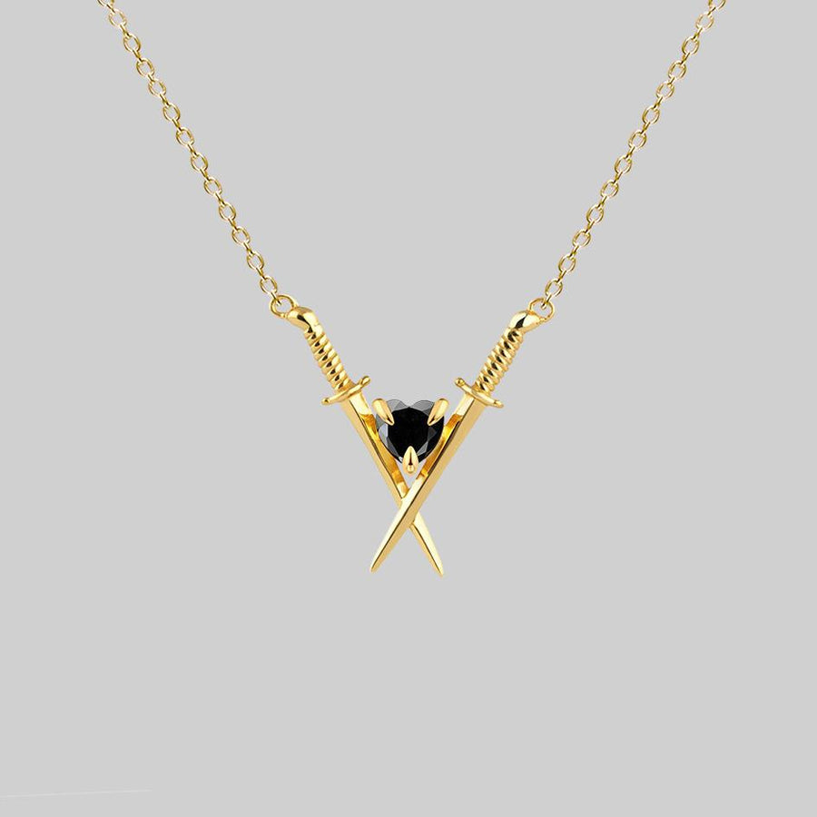 gold swords and heart necklace