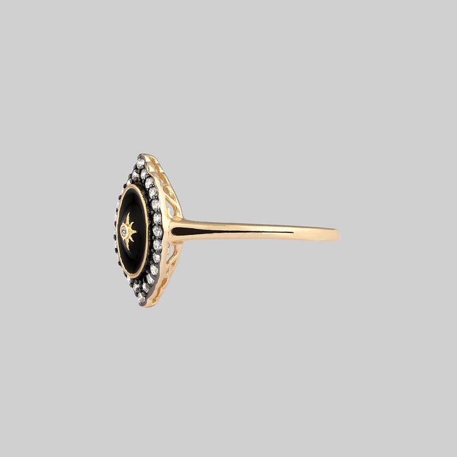 gold ring with crystals and black frame 