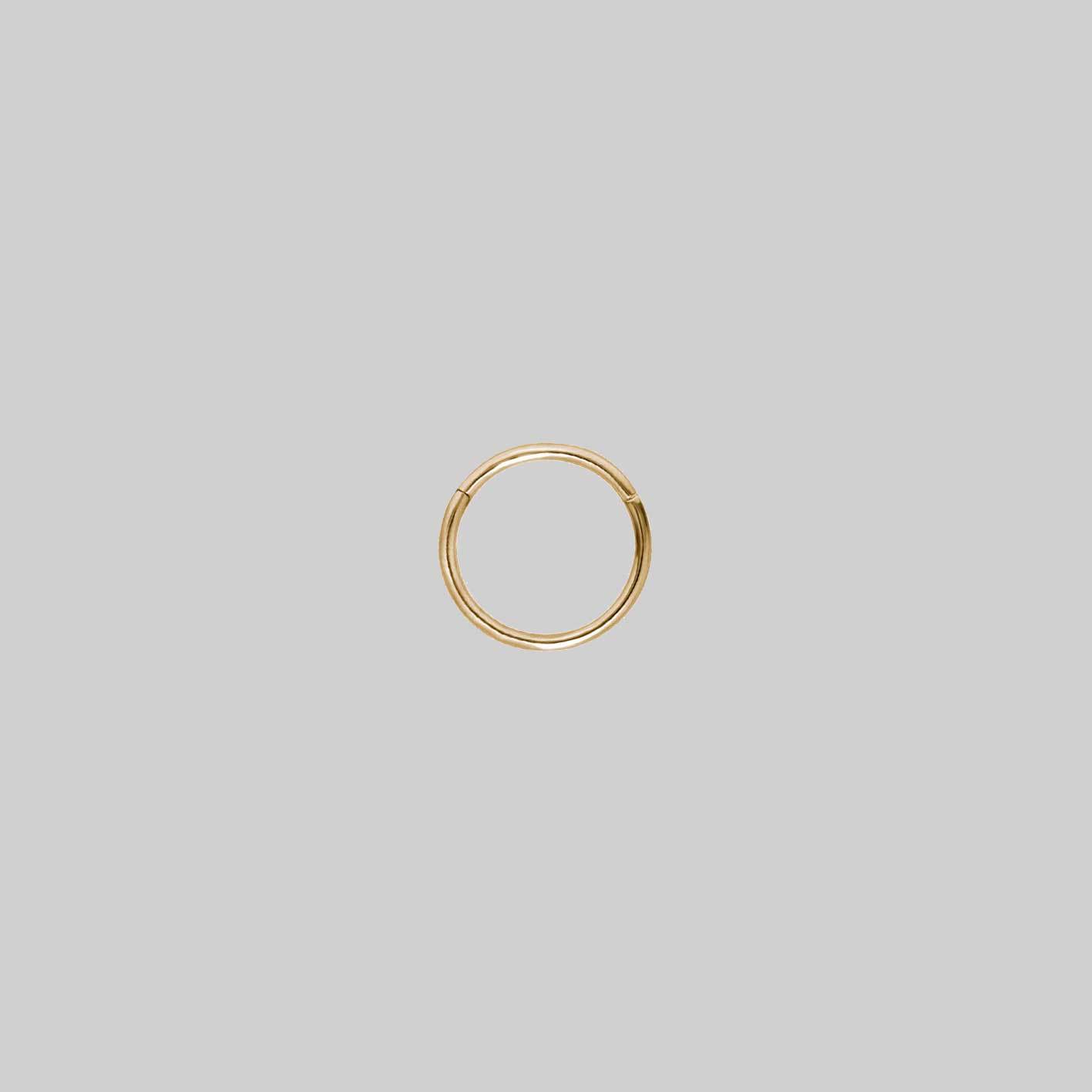 A small gold clicker ring with a simple design