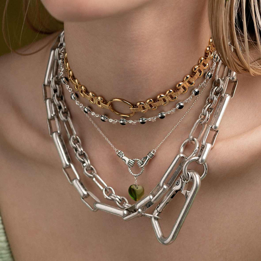 UNITE. Hand Grasping Green Glass Heart Necklace - Silver